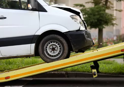 A van being lifted onto a flatbed truck as part of Vehicle Recovery Services in Effingham IL