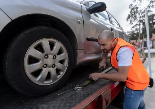 A man getting a car onto a flatbed as part of Local Towing in Effingham IL