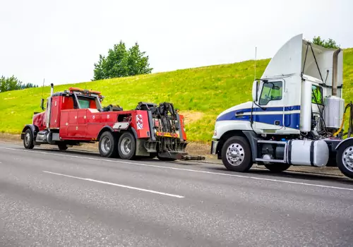 A tow truck preparing to haul a semi-truck as part of Heavy-Duty Towing in Effingham IL