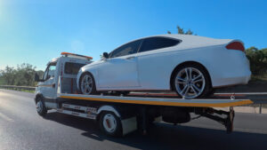 A car is towed as part of services for Tow Trucks Effingham IL