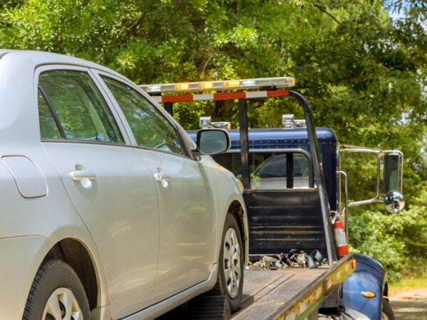 A car needing towing Farina IL services is on the back of a tow truck